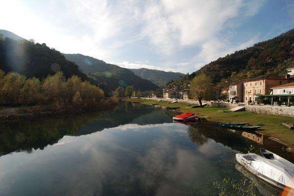 Still river marina with mountains