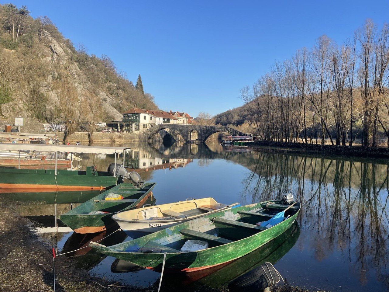 Boats on the river at Rijeka Crnojevića with Danilo's Bridge